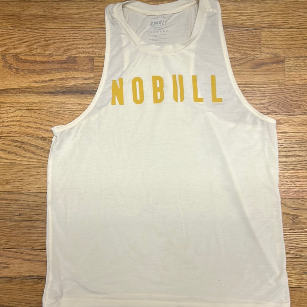 Nobull project pastel yellow tank top with mustard yellow writing.
